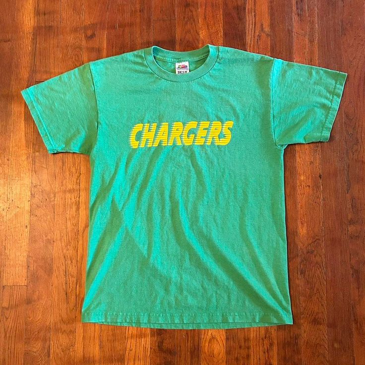 Dope jersey shirt from the '90s. Spellout on front and number on back. Has general wear and some cracking on the number otherwise in good condition. Fits S/M (18.5x26).  Brand: FOTL Size: S Color: Green, Yellow Condition: Good Retro Team Name T-shirt For Streetwear, Throwback Short Sleeve Team Name T-shirt, Green T-shirt With Letter Print For Football Season, Throwback Short Sleeve T-shirt With Team Name, 90s Crew Neck Tops For Game Day, Green Short Sleeve T-shirt For Game Day, Green Team Name Tops For Streetwear, Green College Fan Apparel T-shirt, College Throwback T-shirt With Team Logo