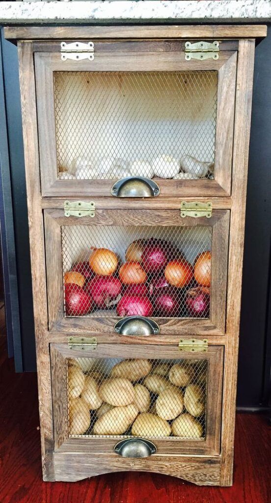 an old wooden cabinet filled with fruit and vegetables