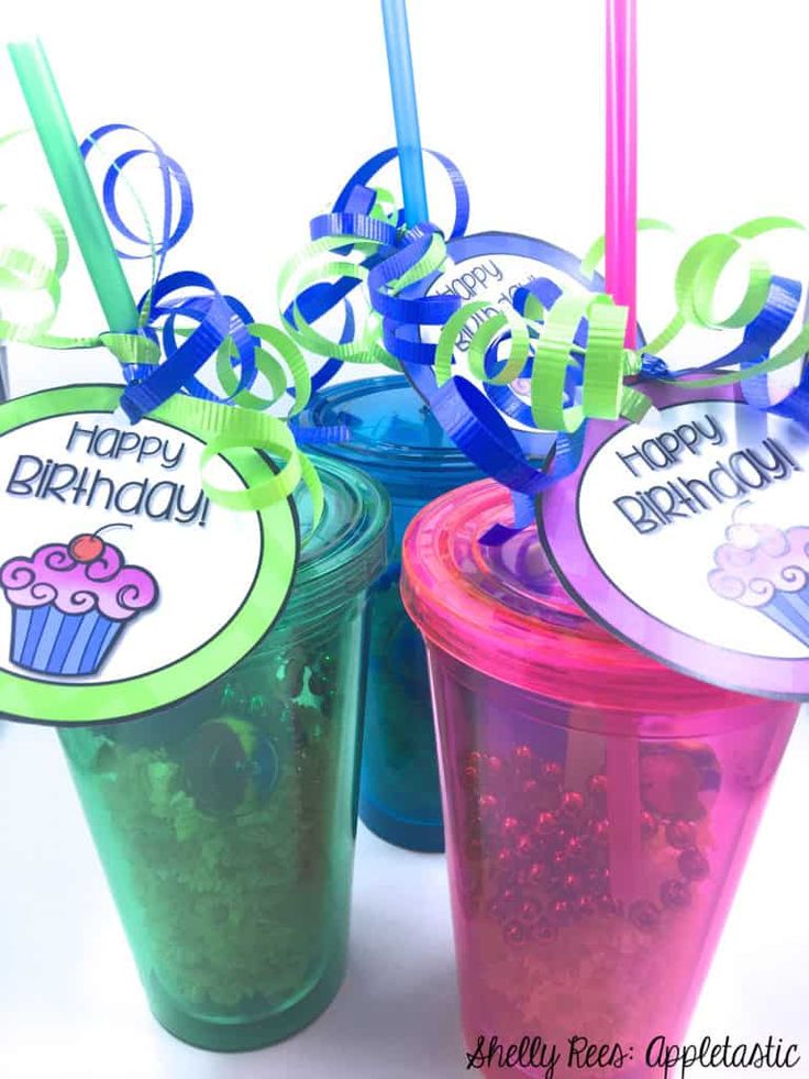 three plastic cups with straws in them and happy birthday tags attached to the lids