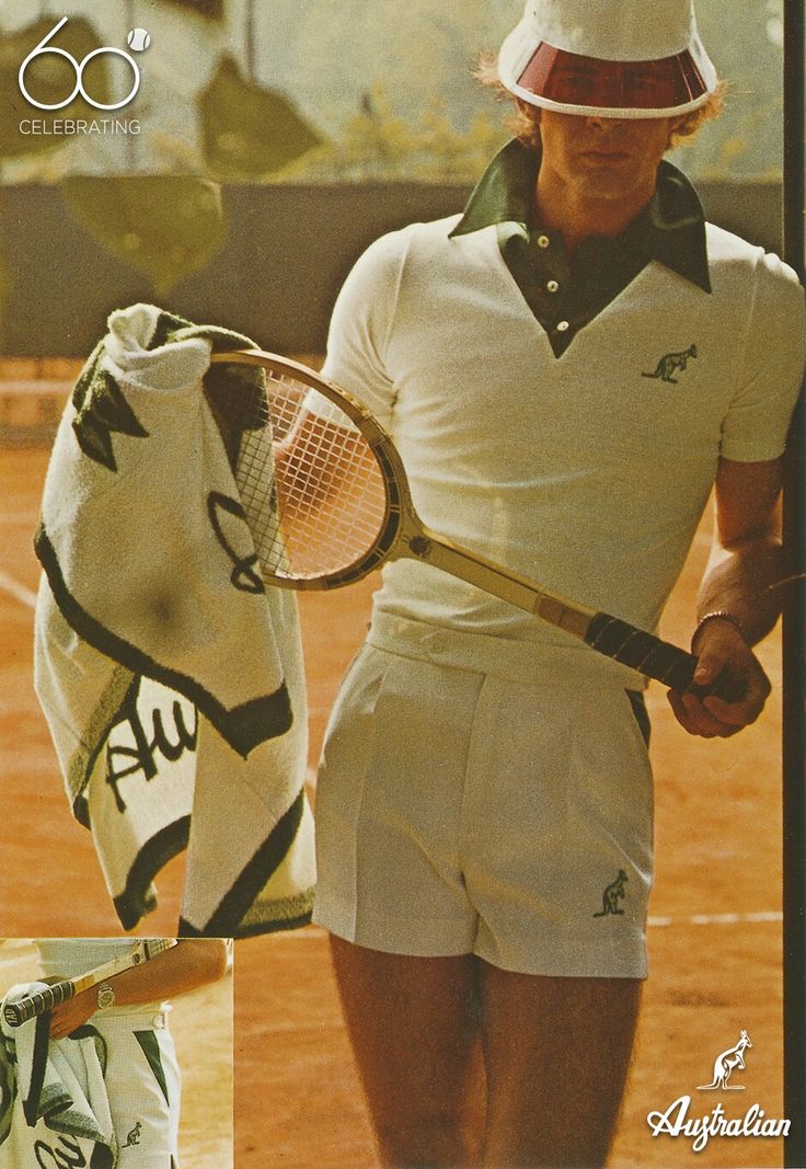 a man holding a tennis racquet standing on top of a tennis court next to a glove