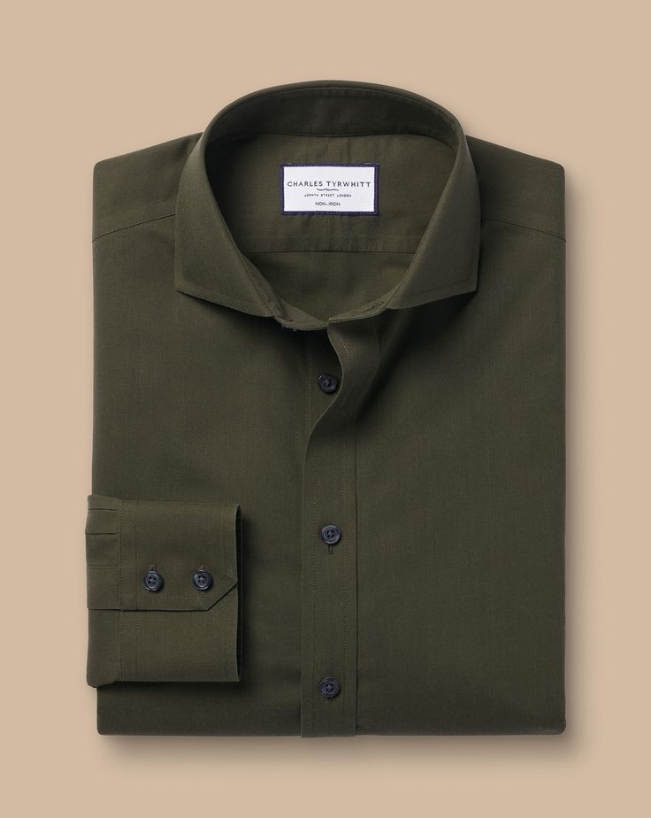 100% cotton, Available in classic, slim and extra slim fit, Non-iron, Spread collar, Classic and slim fit: back pleats, Extra slim fit: back darts, Mitred button cuff with two buttons, Machine washable - Cutaway Collar Non-Iron Poplin Shirt - Olive Green | Men's Charles Tyrwhitt Cutaway Collar Non-Iron Poplin Dress Shirt - Olive Green Single Cuff Size Medium Cotton Classic Unstructured Shirt For Workwear, Classic Unstructured Dress Shirt For Work, Fitted Wrinkle-resistant Tops For Office, Classic Slim Fit Wrinkle-resistant Tops, Casual Fitted Wrinkle-resistant Shirt, Fitted Wrinkle-resistant Dress Shirt For Semi-formal, Green Cotton Business Shirt, Classic Fitted Top For Business Casual, Semi-formal Green Cotton Top