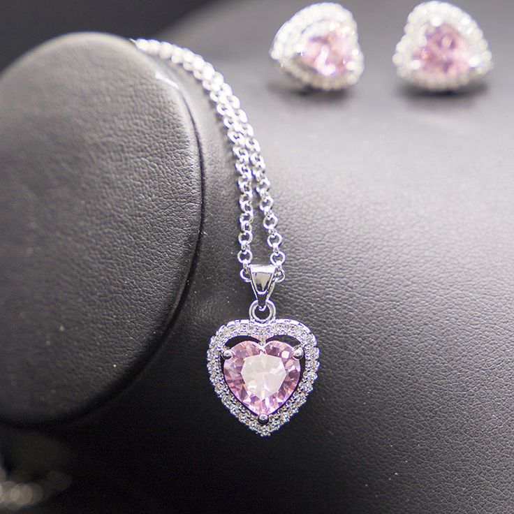 Order now and receive the matching earrings and ring with your set for free! Make a statement when you step out in this Sparkling Crystal Heart Jewelry Set. Lightweight and easy to wear, this jewelry set is designed for the fashion-forward woman. Exclusively available in blue and pink, add this set to any outfit for a Pink Crystal Heart Pendant Jewelry, Elegant Heart Cut Jewelry Sets, Silver Heart Cut Jewelry Sets For Valentine's Day, Valentine's Day Silver Jewelry Sets With Heart Cut, Elegant Heart Shaped Jewelry Set For Mother's Day, Heart-shaped Cubic Zirconia Jewelry Sets For Valentine's Day, Valentine's Day Silver Heart-cut Jewelry Sets, Pink Jewelry Sets For Valentine's Day Party, Rose Gold Crystal Jewelry For Valentine's Day