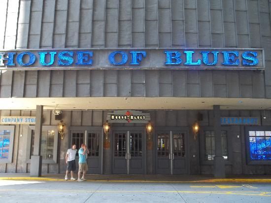 two people standing in front of the house of blues