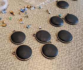 several pieces of black glass sitting on top of a table next to beads and other items