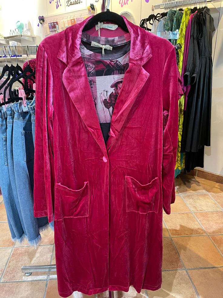 This season, stay chic and cozy in the Must Have Velvet Duster Jacket in Magenta. Crafted of luxurious velvet, this piece features a collar and pockets for a flattering silhouette. A button at the waist shape the fit to perfection. Perfect for Winter, Valentines Day, and pink lovers. This versatile jacket will be your go-to for any occasion. 1 S/M left & L/XL. I'm wearing a S/M. Dark Pink Velvet Jacket, Velvet Outerwear With Lapel Collar For Work, Velvet Single Breasted Outerwear For Fall, Single-breasted Velvet Outerwear For Fall, Single Breasted Velvet Outerwear For Fall, Chic Velvet Outerwear With Notch Lapel, Long Velvet Coat For Fall, Fall Party Outerwear With Hidden Button Closure, Long Sleeve Outerwear With Pockets For Parties