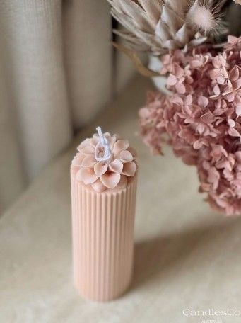 two vases with flowers in them sitting on a table