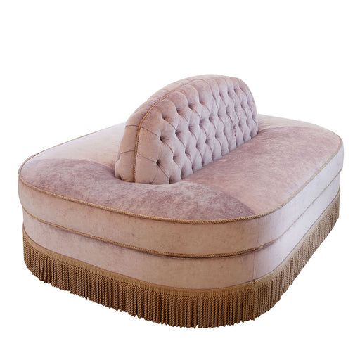 a pink chaise lounge chair with fringe trimmings on the bottom and back