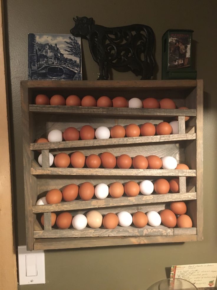 a wooden shelf filled with lots of brown and white eggs