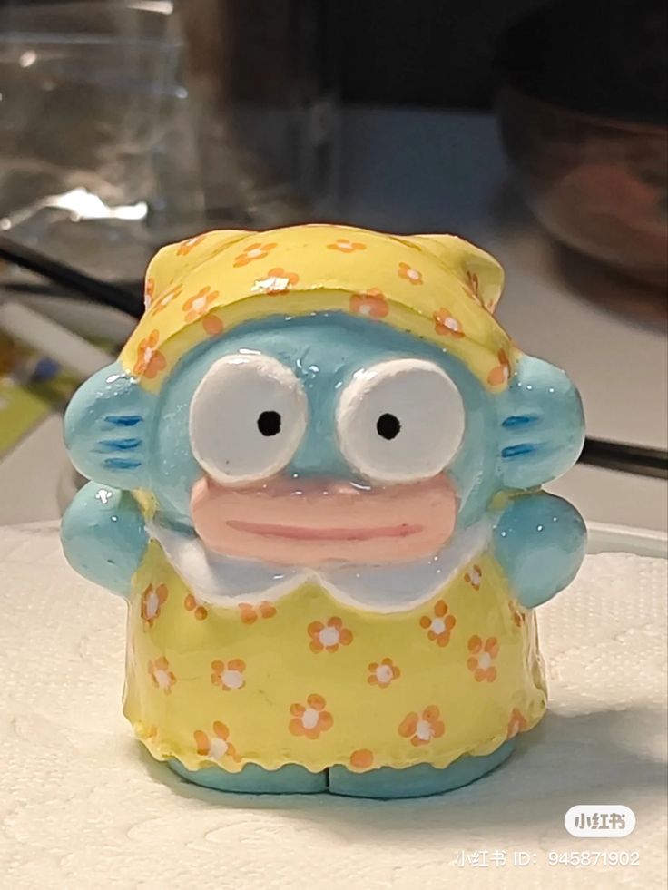 a ceramic monkey figurine sitting on top of a counter