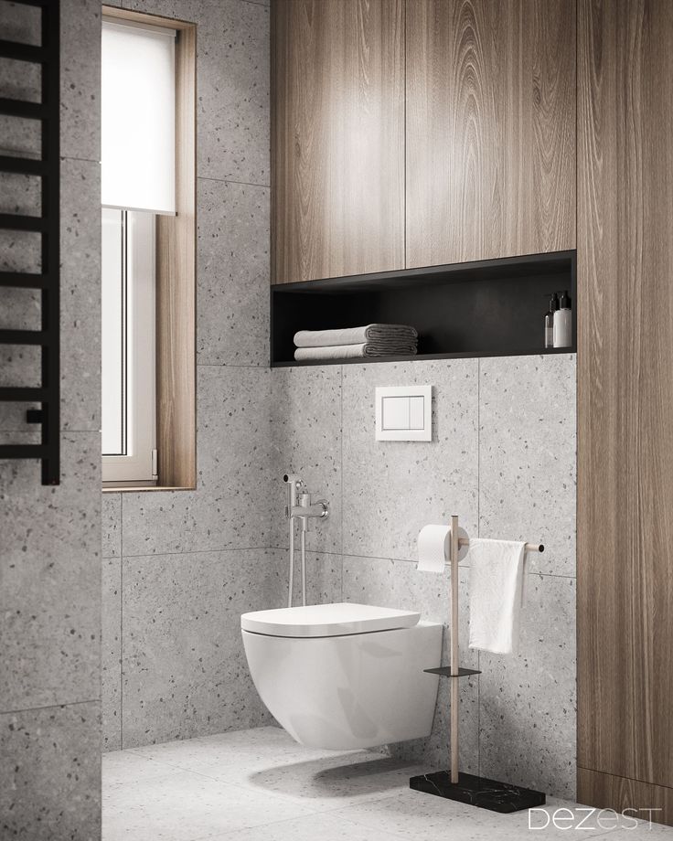 a white toilet sitting in a bathroom next to a wooden cabinet and window above it