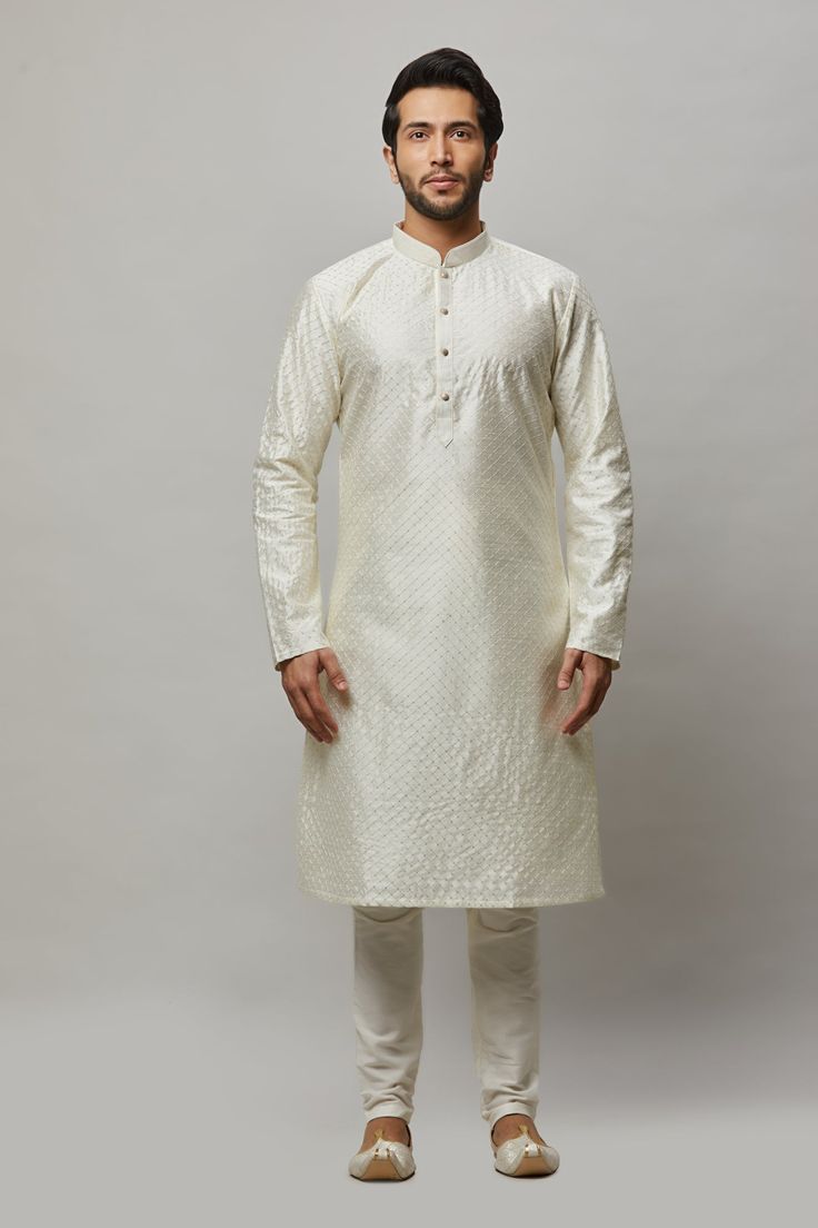 Raw Silk Kurta with thread and gold sequence embroidered in the fabric plus gold churidar Crafted with a collar neckline, full sleeves, and front button closure. Occasion: Can be worn to lighter events like Sangeet, Mehendi, Puja, or a small party WASH CARE INSTRUCTIONS - Please Dry clean only when it is applicable. Slight color variation is possible due to digital photography. White Self-design Churidar For Transitional Season, Off White Straight Kurta For Diwali, Off White Traditional Wear With Self Design For Eid, White Sherwani With Self Design For Puja, Diwali Off White Straight Kurta, White Self-design Sherwani For Puja, Eid Traditional Wear In Off White With Self Design, White Long Sleeve Churidar For Puja, Off White Long Sleeve Formal Kurta