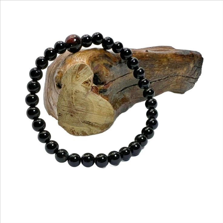 Black Onyx Stretch Bracelet with 6mm beads and 1 8mm Mahogany bead. The beads are powerful stone and gives strength and energy. They are grade AAA beads. Black Gemstone Bead Bracelet, Black Gemstone Beads Rosary Bracelet, Black Beaded Bracelets With 8mm Beads For Healing, Onyx Bracelets With 8mm Beads For Healing, Onyx Crystal Bracelet With Black Round Beads, Black Healing Beaded Bracelets With Round Beads, Black Beaded Bracelets For Healing With 8mm Beads, Black Hand-strung Rosary Bracelet With Round Beads, Hand-strung Black Rosary Bracelet With Round Beads