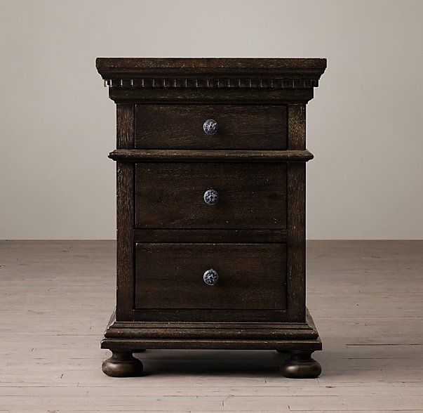 an old wooden chest with three drawers on wheels and one drawer open, sitting on a wood floor