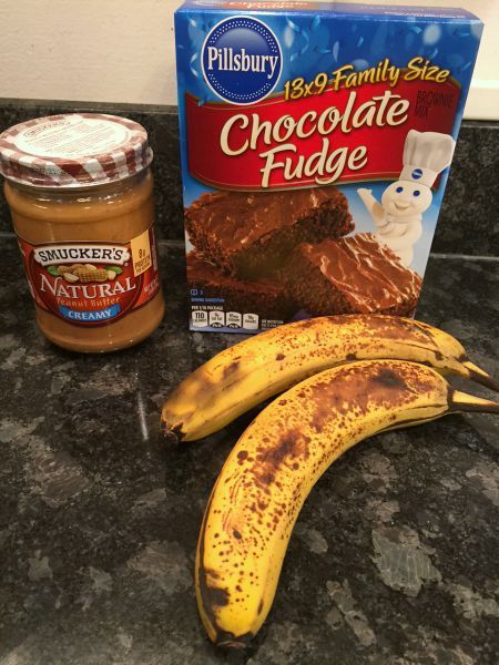 two bananas sitting on top of a counter next to a package of chocolate fudge