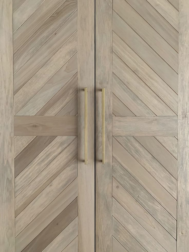 a close up of a wooden door with two handles on the front and back doors