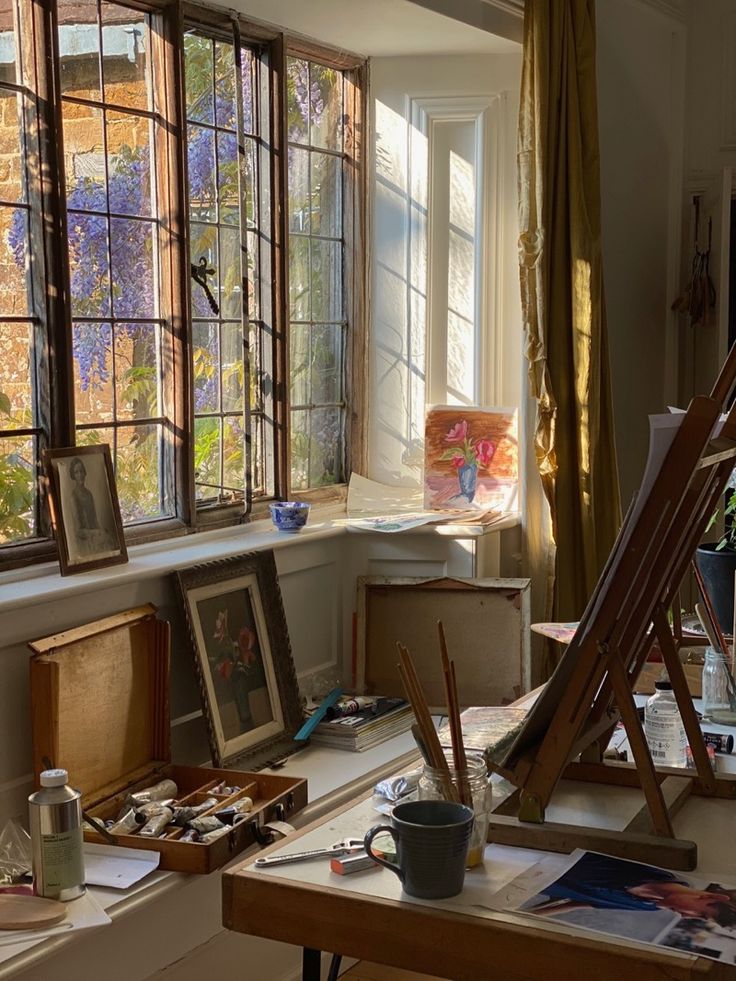 an artist's studio with easels, paintings and other art supplies