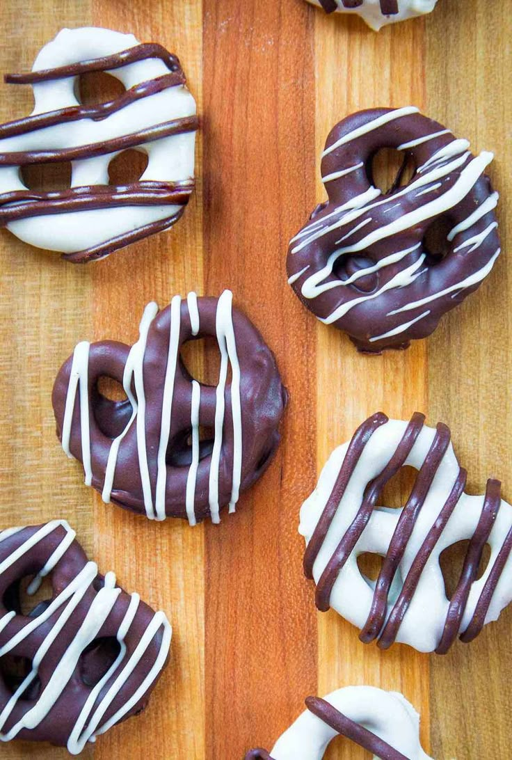 chocolate covered donuts with white frosting on a wooden table