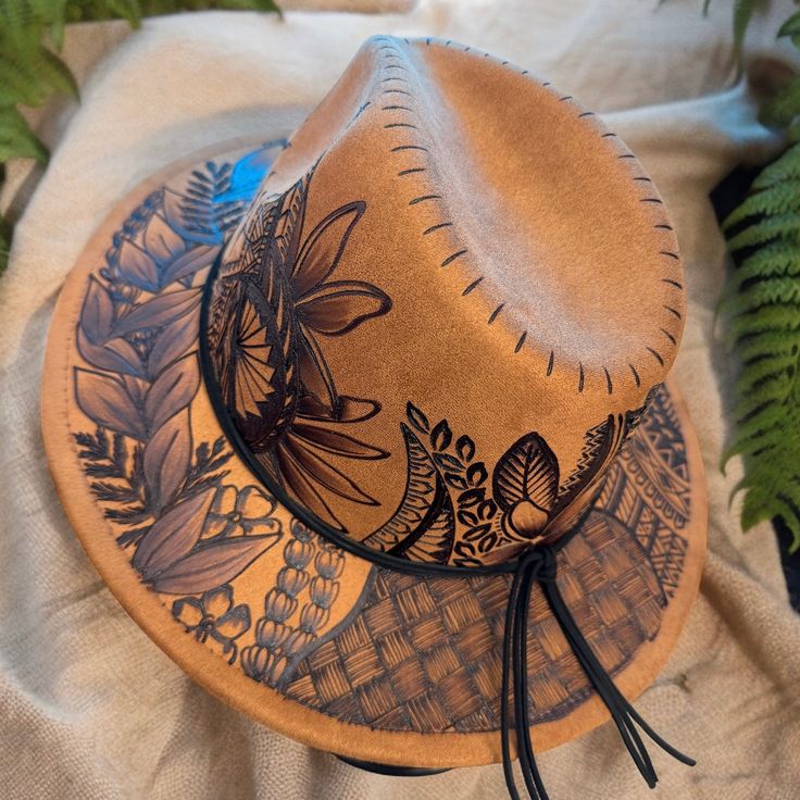 Small Brim Fedora in Khaki. Hat is adjustable from the inner crown for a tighter fit. Burned using Pyrography Techniques. Each Hat is freehanded, making it a hat of its own and a One of a kind. Hats made by Piper come with a Signature travel/dust bag and a handcrafted Macrame Hat Wall Hanger. Hat is sealed for weather for up to 12 months. Artistic Adjustable Hat For Rodeo, Artistic Adjustable Hat Bands For Fedora, Brown Hand Painted Short Brim Hat, Artistic Brown Hats For Festivals, Artistic Brown Hat For Festival, Artistic Brown Festival Hat, Artistic Short Brim Hat For Rodeo, Artistic Curved Brim Hat For Rodeo, Artistic Wide Brim Hat For Rodeo