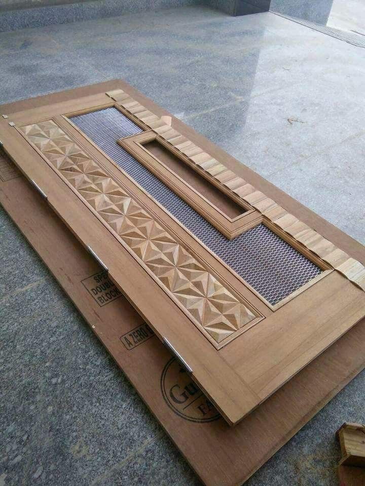 two pieces of wood sitting on top of each other in front of a building window