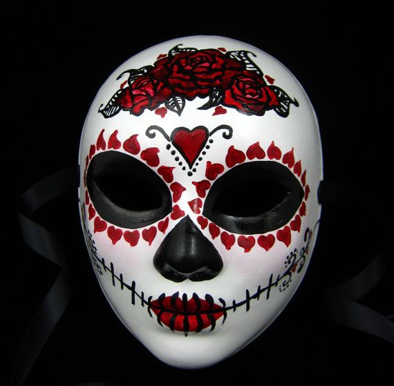 a white mask with red roses painted on it's face and the word love is written in black