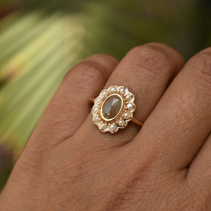 "A cozy fresh water pearl halo around a 1.27 carat chocolate brown rough diamond, bezel set in solid 14k gold - this ring is a hot chocolate on a cold day! A perfect alternative bridal ring, this unique ring also makes for a stunning long distance winter holiday gift! * Gold : 14k Solid Yellow Gold * Gold Wt. : ~3.5gms * Gemstone 1 (Centre) : Natural Diamond * Diamond Color : Light Muddy Brown * Diamond Weight : 0.76 Ct * Gemstone 2 (Halo) : Fresh Water Pearls * Weight : 0.66 Ct * Authenticity C Dark Academia Engagement Ring, Pearl Halo Ring, Brown Diamond Engagement Ring, Bridal Proposal, Pearl Halo, Ring With Pearl, Brown Ring, Brown Diamond Ring, Brown Rings