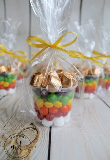 small plastic bags filled with candy on top of a wooden table