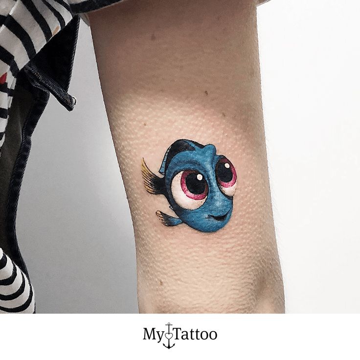 a small tattoo on the leg of a woman with an evil looking eyeball in it