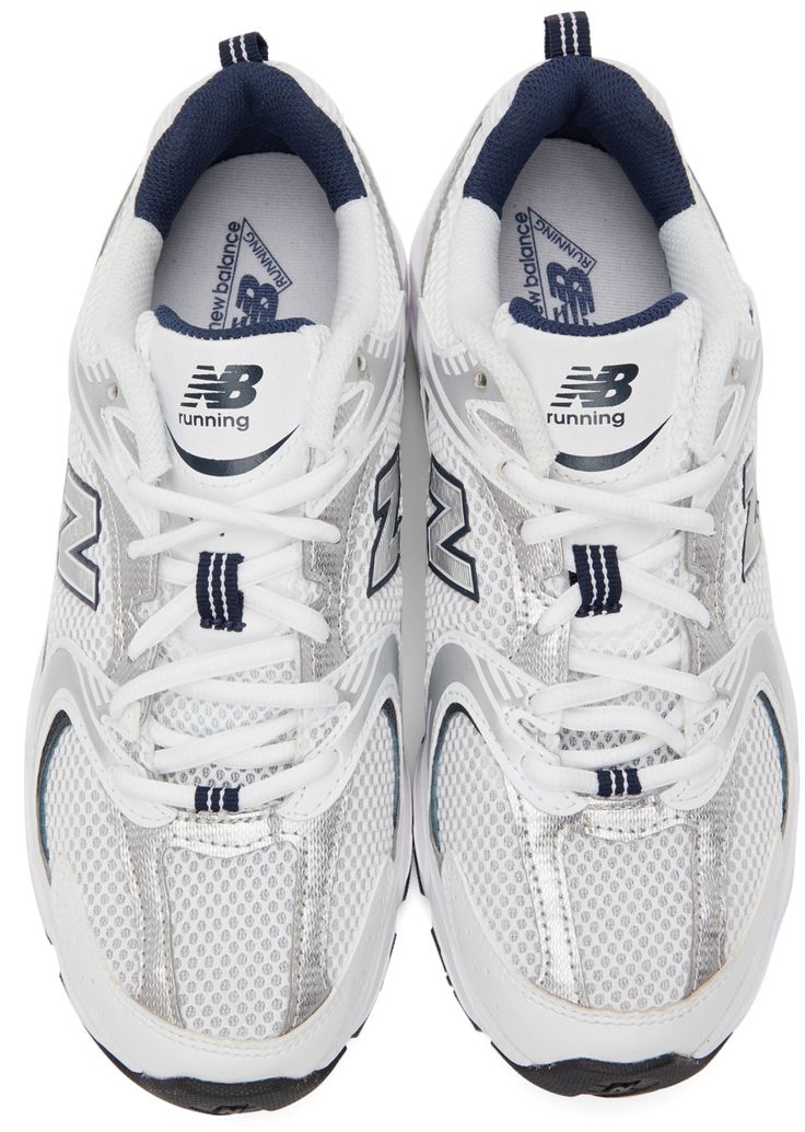 Low-top mesh sneakers in white. Tonal and reflective silver-tone faux-leather trim throughout. Round toe. Lace-up closure in white. Logo printed in blue at padded tongue. Padded collar. Grosgrain pull-loop in navy at heel collar. Rubberized logo appliqué in silver-tone and black at sides. Printed logo in navy at outer sides. Rubberized logo appliqué in black at ABZORB foam rubber midsole in white. Treaded rubber outsole in black, grey, and blue. Supplier color: Grey New Balance White, New Balance Outfit, Low Top, Print Logo, White Silver, Luxury Streetwear, Leather Trims, New Balance, Faux Leather