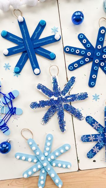 paper snowflakes and other crafting supplies laid out on a table