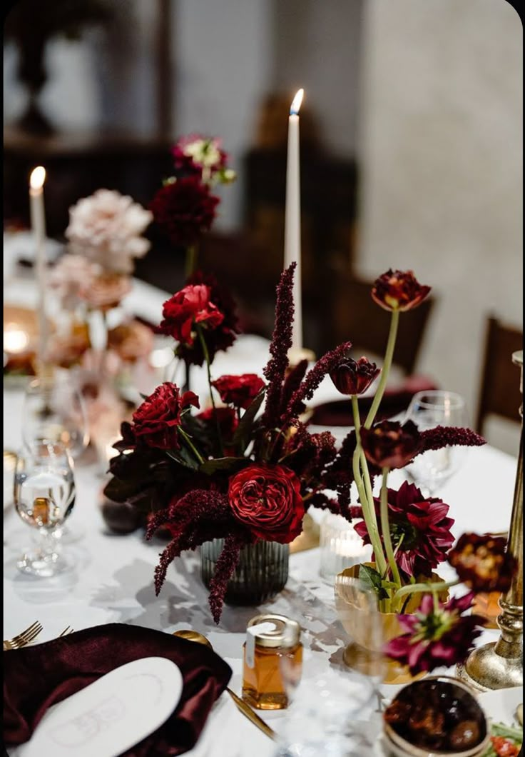 the table is set with flowers and candles