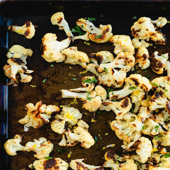 roasted cauliflower on a baking sheet ready to be cooked in the oven,