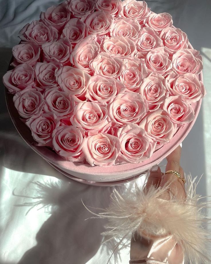 a pink hat with roses in it