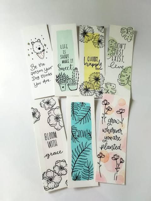 four bookmarks with different designs on them, one has flowers and the other has words