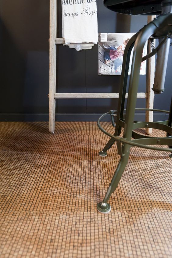 a kitchen with an old fashioned bar stool next to a sign on the wall above it