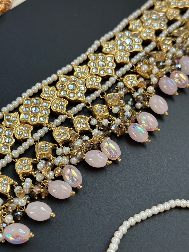 This lightweight and dainty set in thapa kundan or multani work is made of high quality gold plating and has gorgeous pink crystal drops that have an ombre finish. The colors are super unique and pastel so that they can go with any outfit whether its a saree or lehenga! and can be worn separately for a simple look. This lightweight and elegant necklace is perfect for any bridesmaid, bride, sangeet or any occasion or event as a gift for any occasion as any one who loves jewelry will love this sta Elegant Multicolor Kundan Lehenga, Elegant Pink Jewelry Sets For Diwali, Festive Pink Necklace With Stone Work, Festive Pink Necklaces With Stone Work, Elegant Gold Dupatta With Tilla Detail, Pink Traditional Necklace With Stone Work, Pink Jewelry Sets For Diwali Party, Traditional Pink Necklace With Stone Work, Traditional Rose Gold Jewelry Sets For Festive Occasions