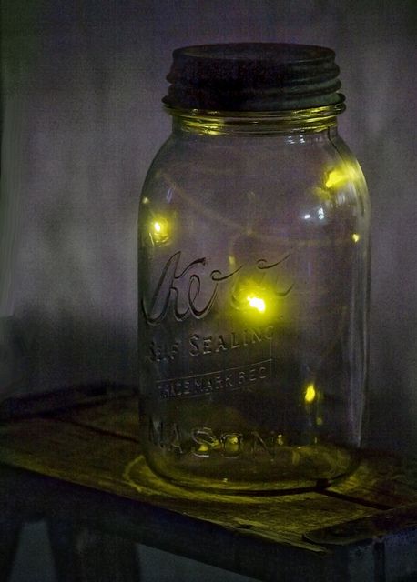 a mason jar with some yellow lights in it