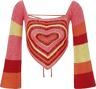 a crocheted heart is hanging on a clothesline with an orange, pink and yellow strip