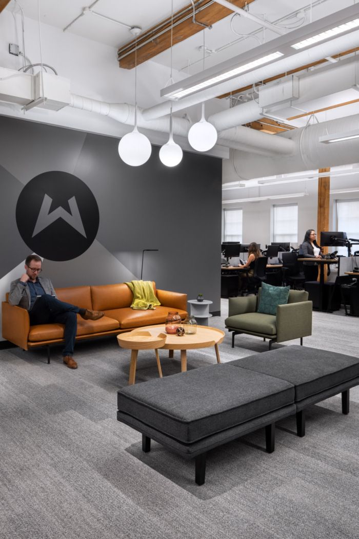 a man sitting on a couch in an office