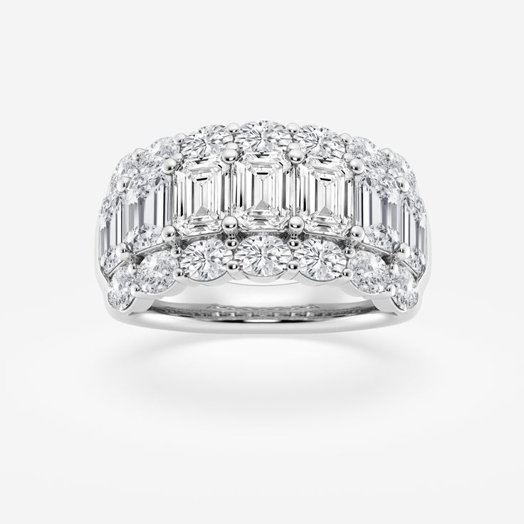 a white gold ring with baguetts and diamonds on top, set in 18k white gold