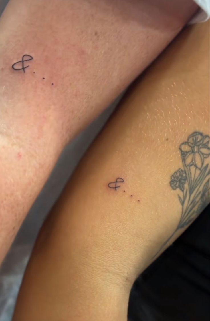 two people with tattoos on their legs and one has a flower tattoo on the arm