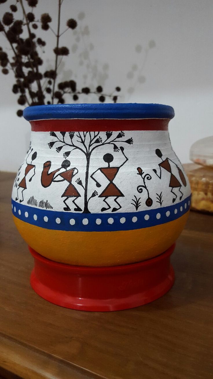 a ceramic pot sitting on top of a wooden table