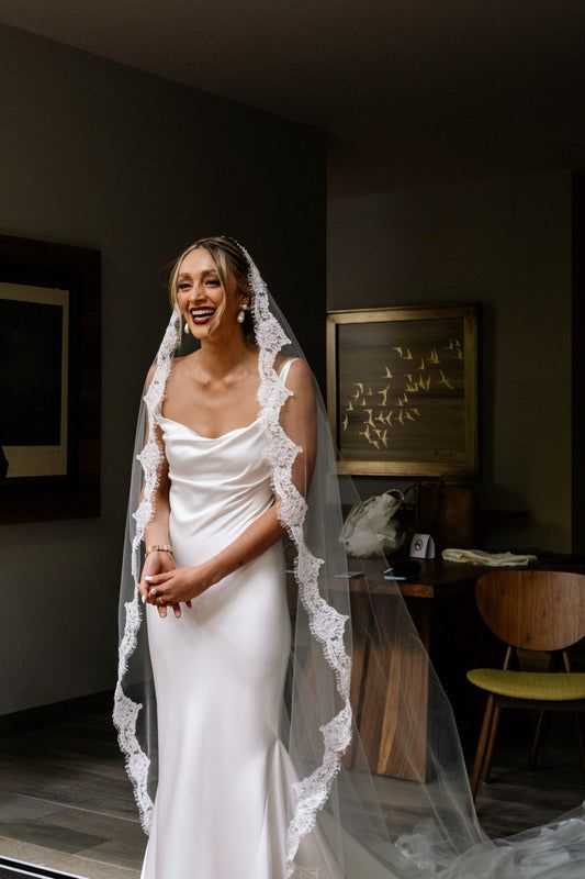 a woman in a white wedding dress and veil