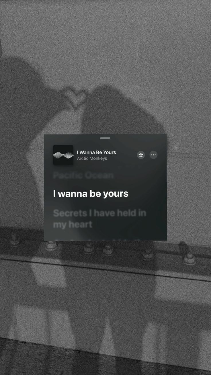 two people standing next to each other in front of a sign that says i wanna be yours