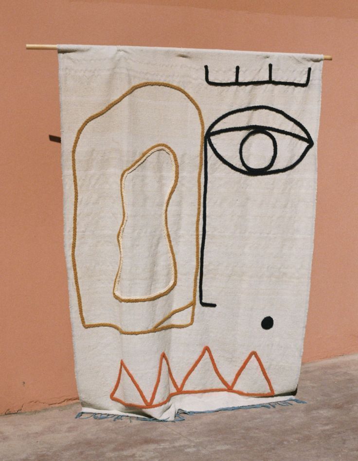 a towel hanging on a clothes line with an eye drawn on it's side