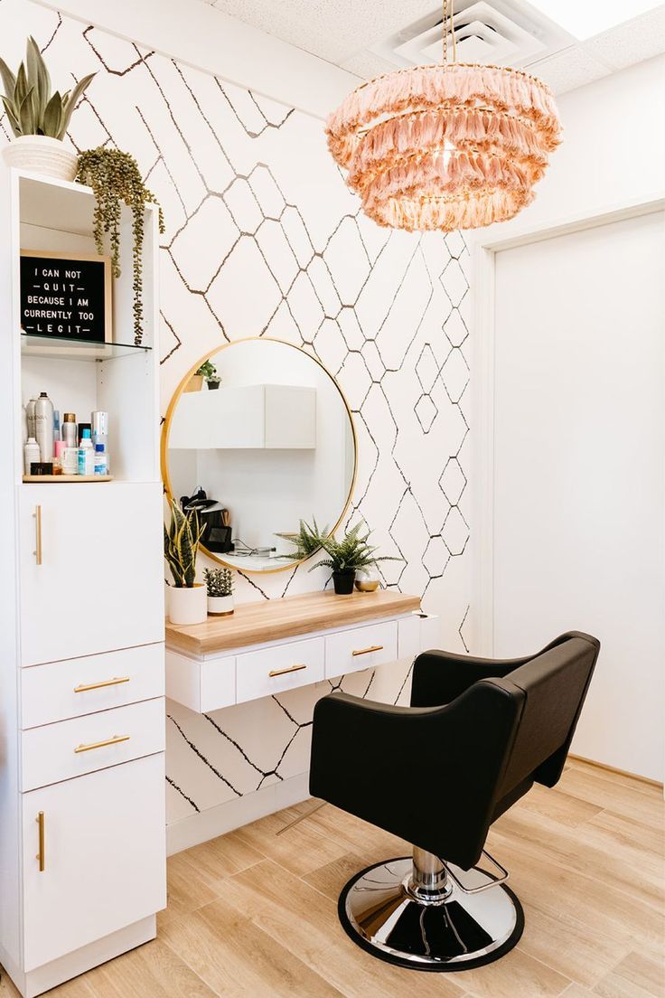 a room with a chair, desk and mirror