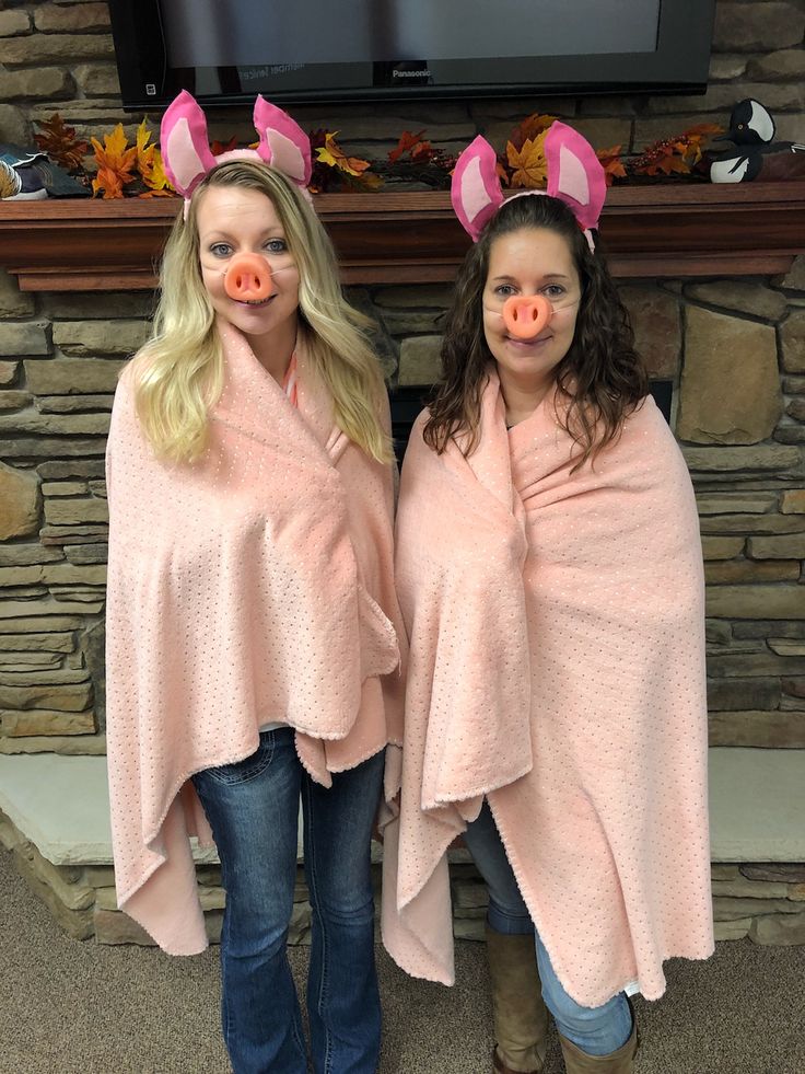 two girls wearing pig ears and scarves