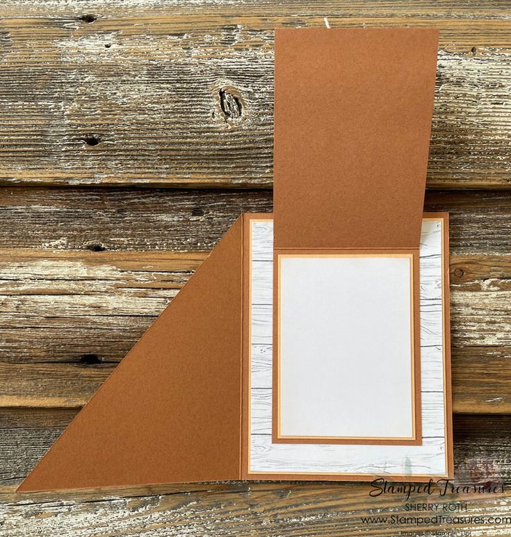 an old wooden wall with a piece of paper on top of it and a blank card in the middle