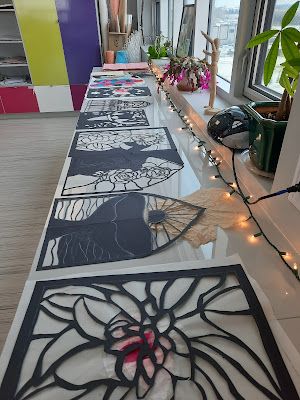 the long table is decorated with black and white paper cutouts, string lights, and potted plants