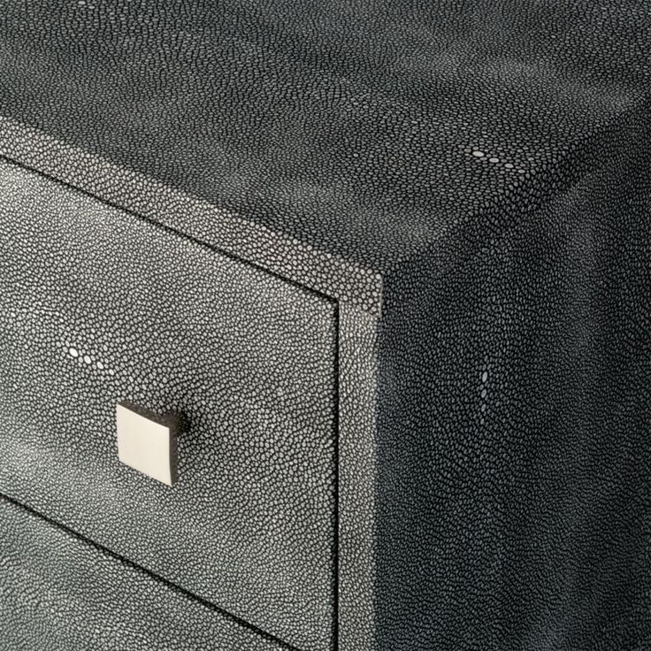 a close up of a black leather drawer with two drawers on one side and a metal handle on the other