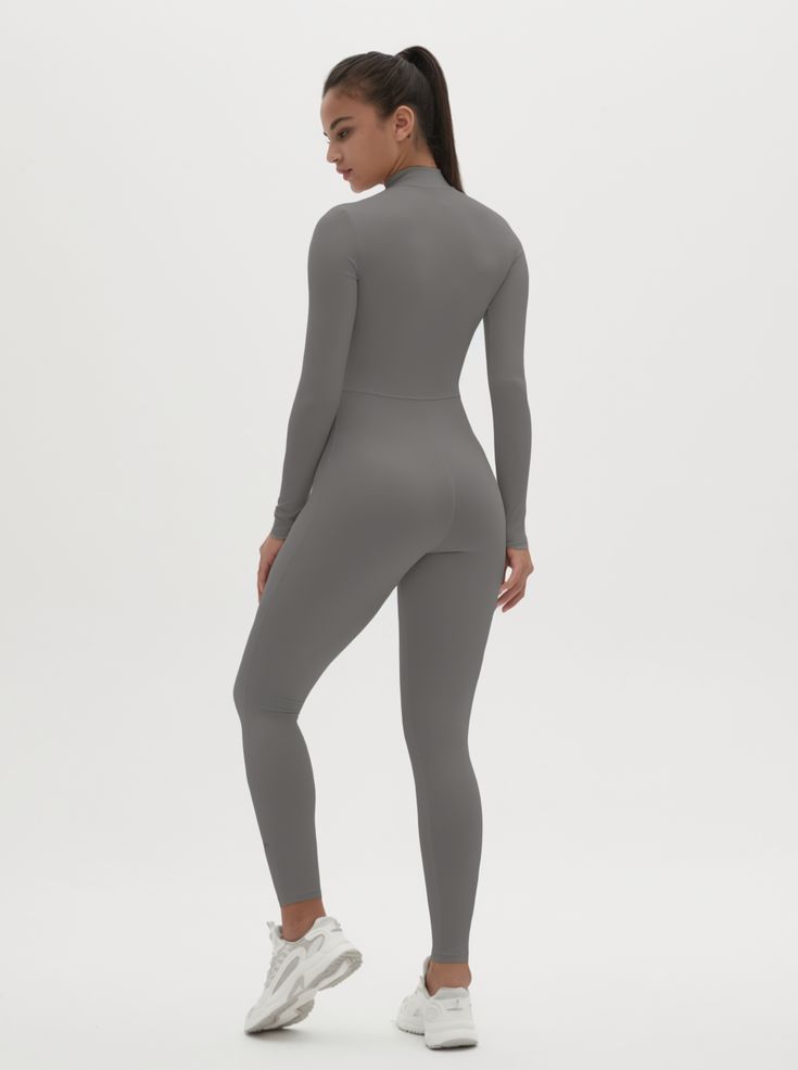 Why We Love It: The Hannah Long Sleeve Zipper Bodysuit is the epitome of sleek, modern activewear. This bodysuit combines functionality with a streamlined design, ensuring you look and feel your best whether you're at the gym or out and about. Fit and Features: Front Zipper Detail: The front zipper allows for easy wear and adjustability, adding a chic element to this versatile piece. Long Sleeves with Thumbholes: Provides added coverage and a secure fit, perfect for cooler weather or intense workouts. Buttery Soft Fabric: This bodysuit feels like a second skin, offering unmatched comfort and flexibility. High Performance: The four-way stretch material ensures maximum freedom of movement, making it ideal for any activity. Moisture-Wicking Technology: Keeps you dry and comfortable, no matter Fitted Athleisure Bodysuit For Gym, Sleek Stretch Bodysuit For Sports, Sleek Sports Bodysuit Stretch Fit, Sleek Sports Bodysuit With Stretch, Sleek Stretch Sports Bodysuit, Solid Color Fitted Unitard For Gym, Sleek Second-skin Bodysuit For Workout, Sleek Second-skin Workout Bodysuit, Solid High Stretch Bodysuit For Athleisure